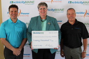 Emile Clavet (left) and Kevin Dean, owners of Electricity Maine present a check for $20,000 to Becky Dyer of the Barbara Bush Foundation.