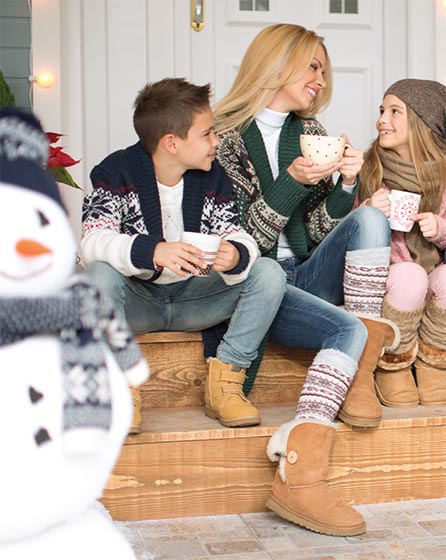 Woman and children drinking hot chocolate.