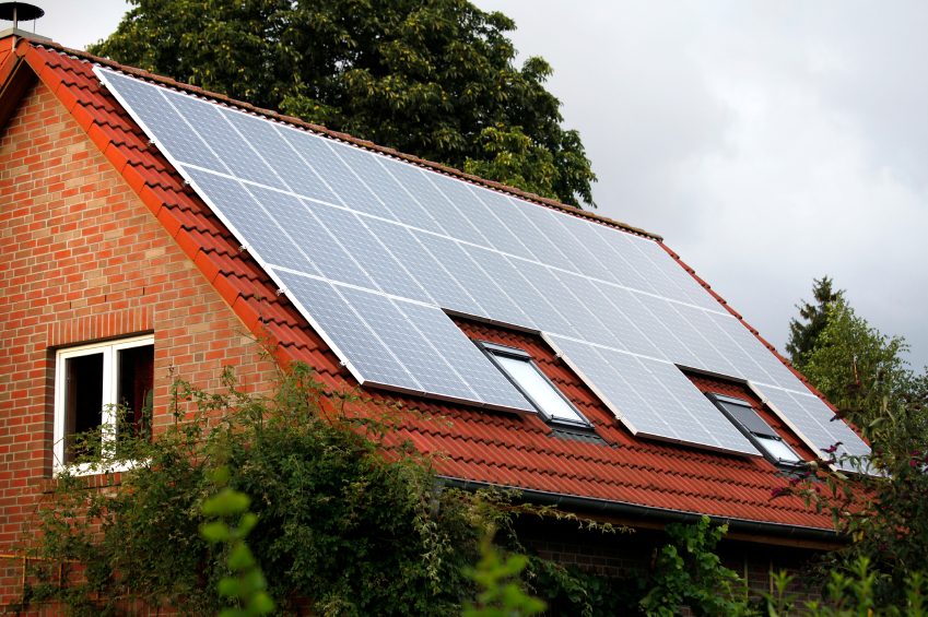 Home with red roof with solar panels