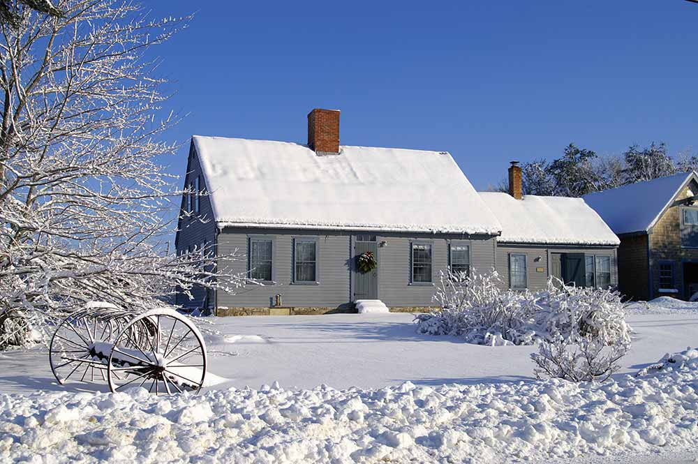 Home covered and surrounded by snow
